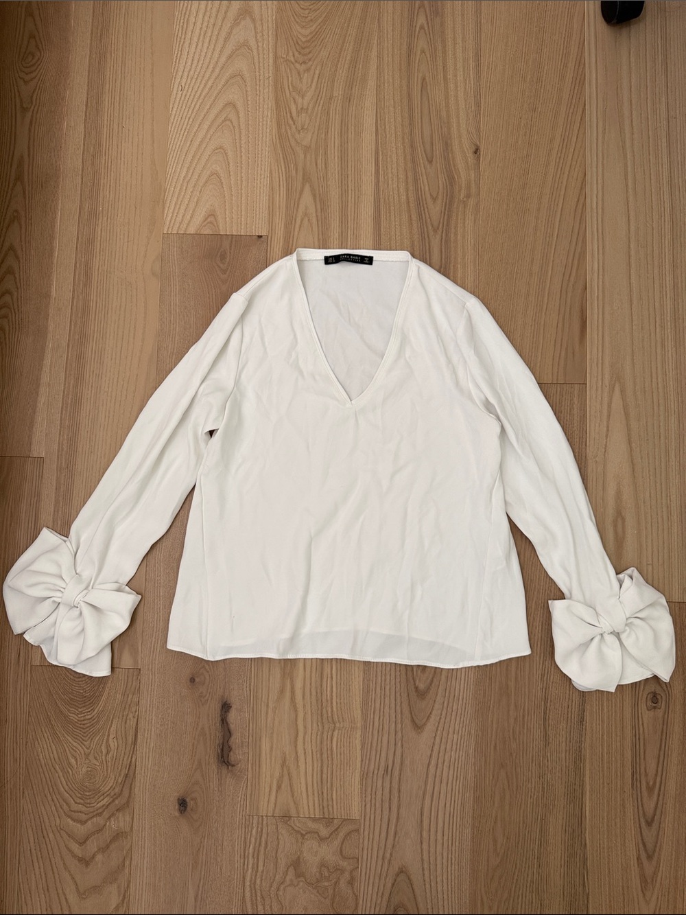 Zara White V-Neck Blouse with Bow Tie Cuffs